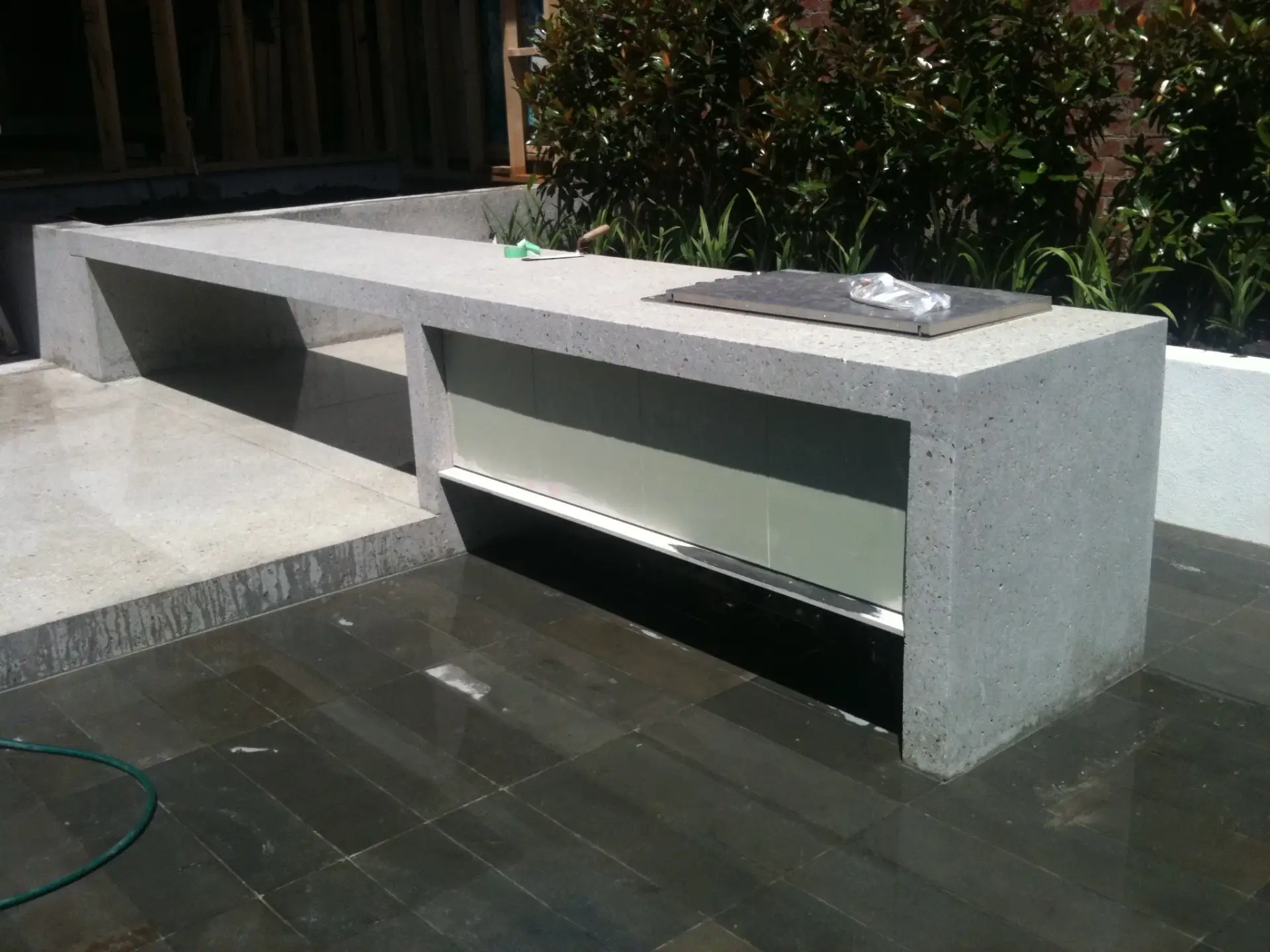 Custom-formed concrete outdoor kitchen and seating installation