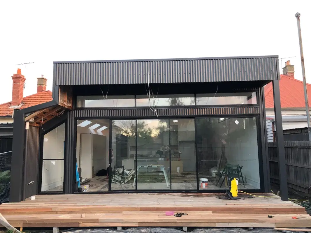 Timber deck build in progress with architectural black exterior cladding